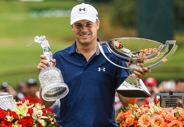 epa04953677 Jordan Spieth of the US lifts the TOUR Championship trophy and the FedEx cup during the trophy presentation after winning the TOUR Championship and FedEx Cup final at East Lake Golf Club in Atlanta, Georgia, USA, 27 September 2015.  EPA/TANNEN  MAURY