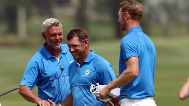KUALA LUMPUR, MALAYSIA - JANUARY 15: Darren Clarke captain of Team Europe congratulates Lee Westwood while Chris Wood looks on on the 17th hole after Europe leads Asia in day one during the four-ball match play at Glenmarie G&CC on January 15, 2016 in Kuala Lumpur, Malaysia. (Photo by Stanley Chou/Getty Images)