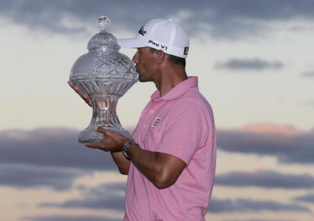 Adam Scott, of Australia kisses the trophy after winning the Honda Classic golf tournament with a 9-under-par, Sunday, Feb. 28, 2016, in Palm Beach Gardens, Fla. (AP Photo/Lynne Sladky)
