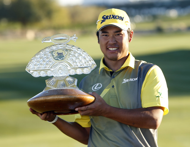Hideki Matsuyama holds the trophy after winning the Phoenix Open golf tournament, Sunday, Feb. 7, 2016, in Scottsdale, Ariz. (AP Photo/Rick Scuteri)