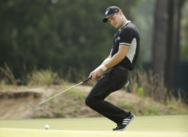 Martin Kaymer, of Germany, reacts to his missed birdie on the 17th hole during the second round of the U.S. Open golf tournament in Pinehurst, N.C., Friday, June 13, 2014. (AP Photo/Chuck Burton)