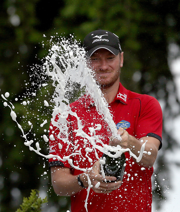 England's Chris Wood celebrates after winning the PGA Championship at Wentworth Club, in Virginia Water, England, Sunday May 29, 2016. Wood shot a front-nine 29 before overcoming a late run of bogeys to win the PGA Championship by one stroke for the biggest victory of his career on Sunday. (Steve Paston / PA via AP) UNITED KINGDOM OUT - NO SALES - NO ARCHIVES