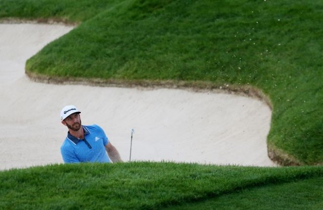 Jun 18, 2016; Oakmont, PA, USA; Dustin Johnson hits out of a bunker on the 13th hole during the third round of the U.S. Open golf tournament at Oakmont Country Club. Mandatory Credit: Charles LeClaire-USA TODAY Sports
