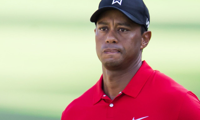 Tiger Woods watches a chip shot to the 15th green during the final round of the Wyndham Championship golf tournament at Sedgefield Country Club in Greensboro, N.C., Sunday, Aug. 23, 2015. (AP Photo/Rob Brown) ORG XMIT: NCRB