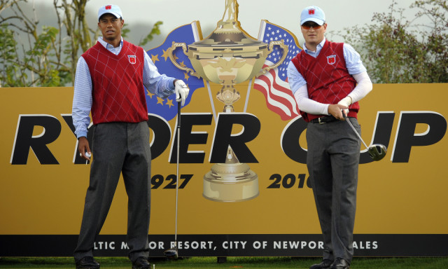 US Ryder Cup player Tiger Woods (L) watches as team mate Zach Johnson plays his tee shot from the fourth during a practice session at Celtic Manor golf course in Newport, Wales on September 28, 2010. The 2010 Ryder Cup between US and Europe begins on October 1, 2010. AFP PHOTO/TIMOTHY A. CLARY (Photo credit should read TIMOTHY A. CLARY/AFP/Getty Images)