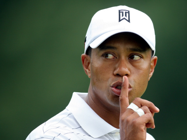 Tiger Woods of the United States gestures to a fan to be quiet from the fifth green during first round play at the WGC Bridgestone Invitational golf tournament in Akron