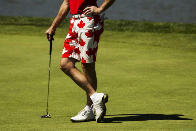 An amateur wears shorts draped with maple leaves in colours of the Canadian flag during the pro-am at Canadian Open golf tournament at the Glen Abbey Golf Club in Oakville
